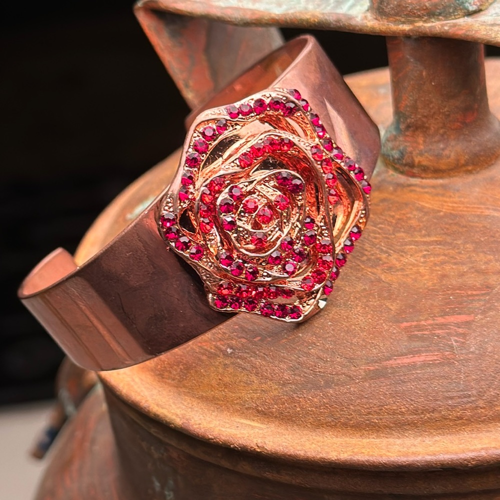 Copper cuff bracelet with red rhinestone flower front